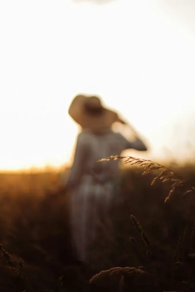 Silhouette féminine floue dans les herbes dorées — conséquences psychiques des violences sexuelles et dissociation